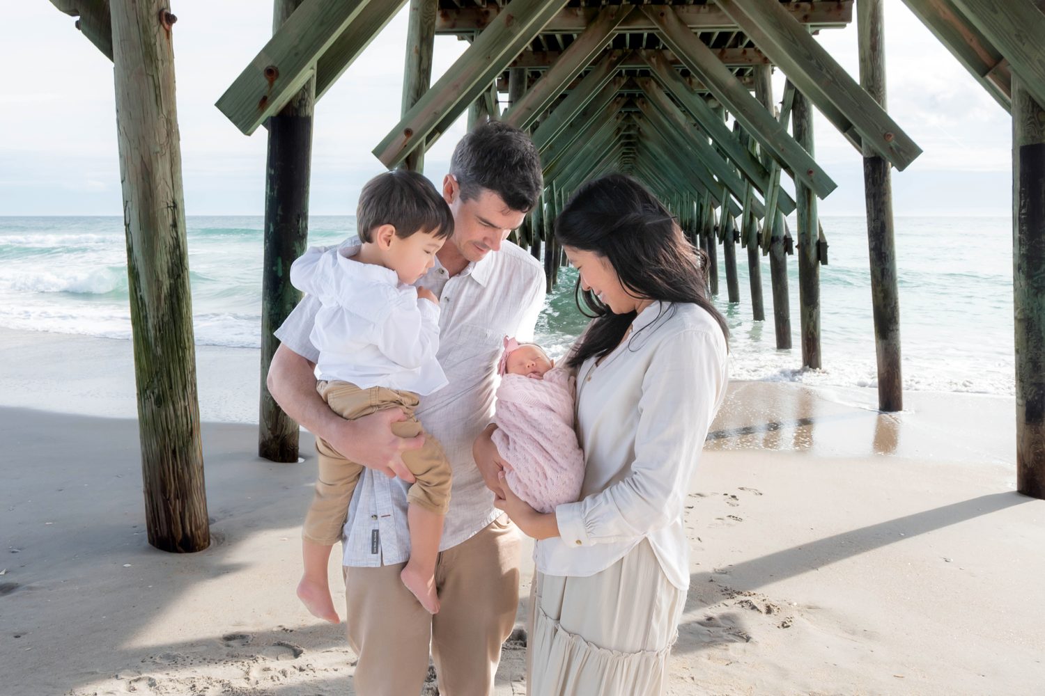 Dr. Jennifer Pan with her family under the Wrightsville Beach pier